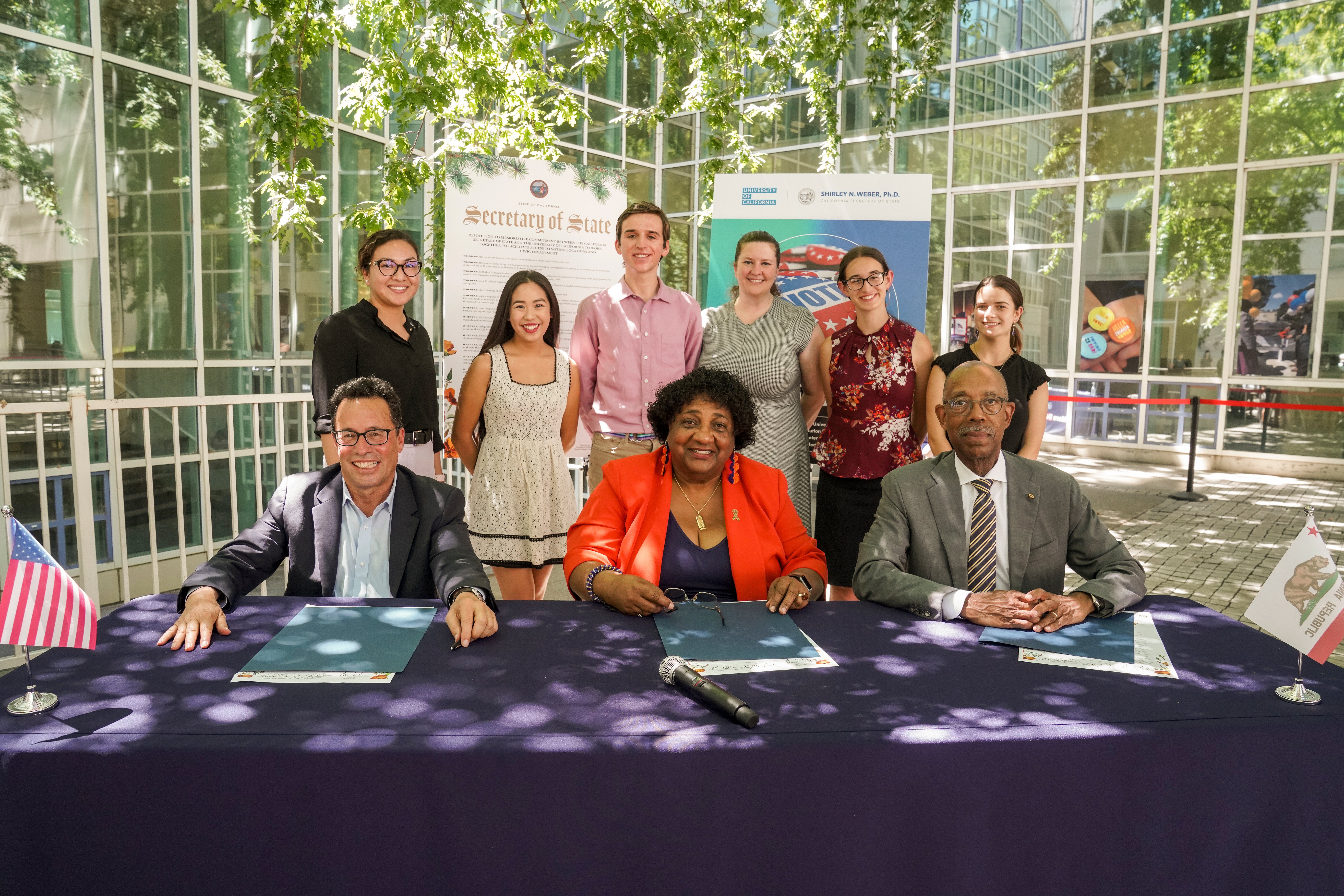UC Board of Regents Vice Chair Leib, California Secretary of State Weber, and UC President Drake sign voting resolution joined by students at UC Davis.