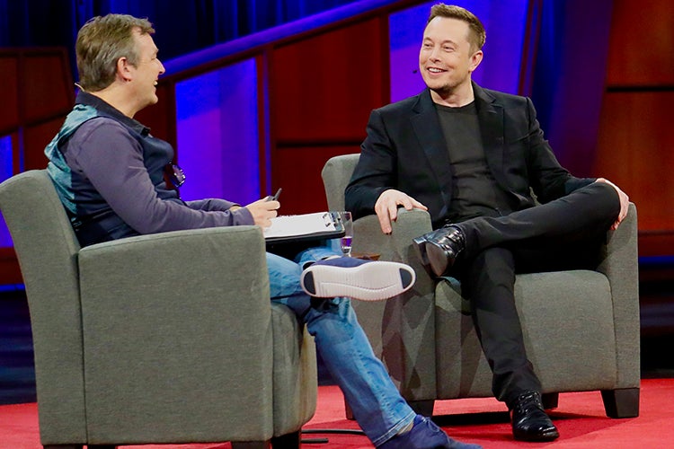 Elon Musk at a TED talk, seated
