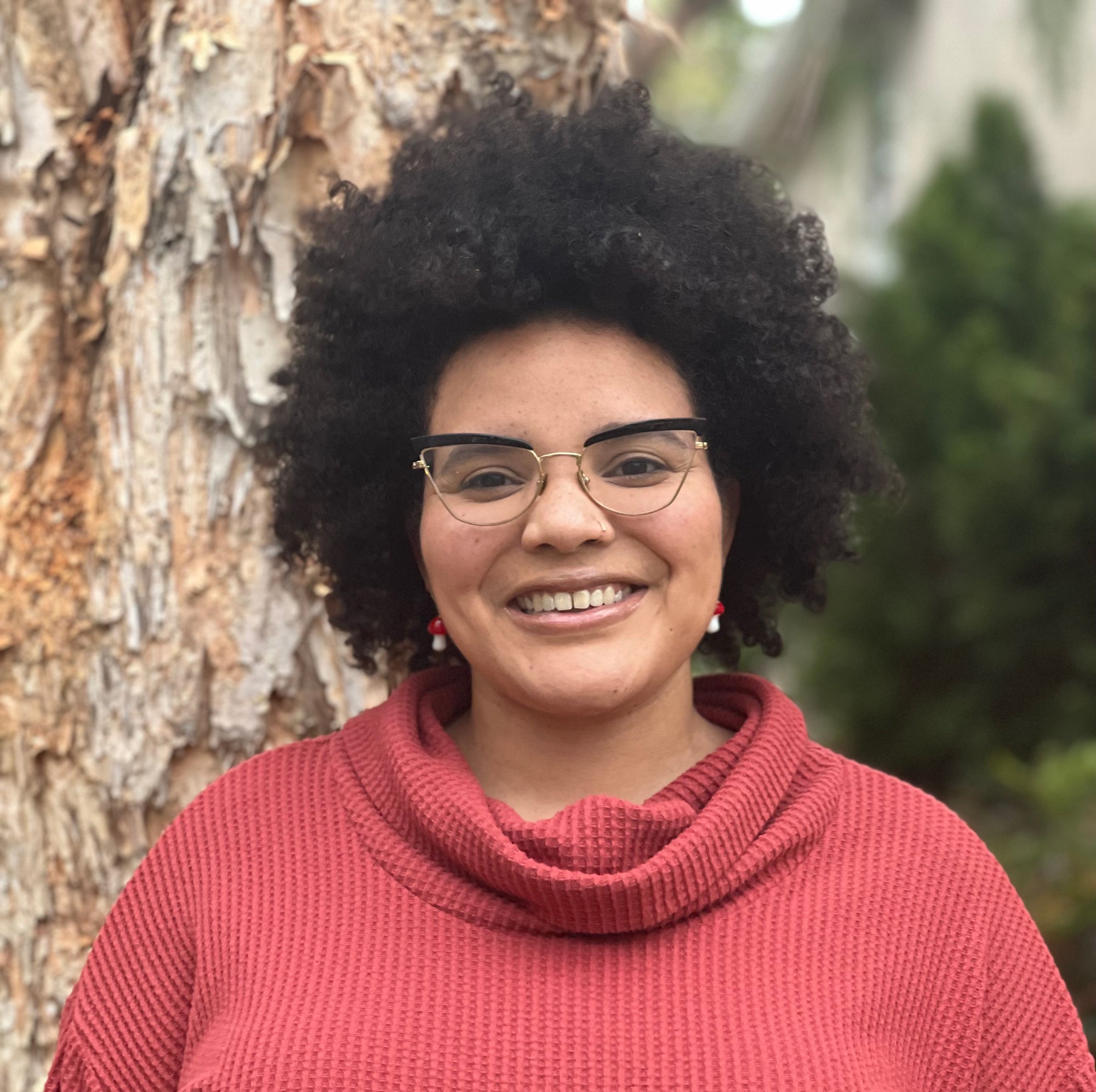 A person standing in front of a tree