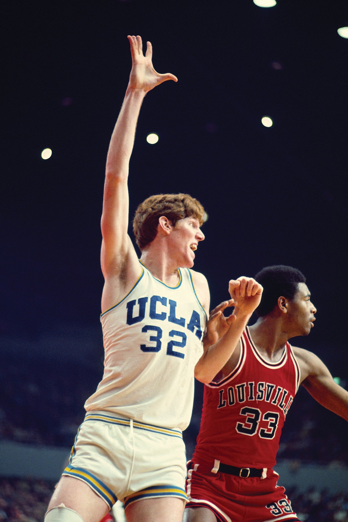 Bill Walton posts up against a Louisville player in the 70s