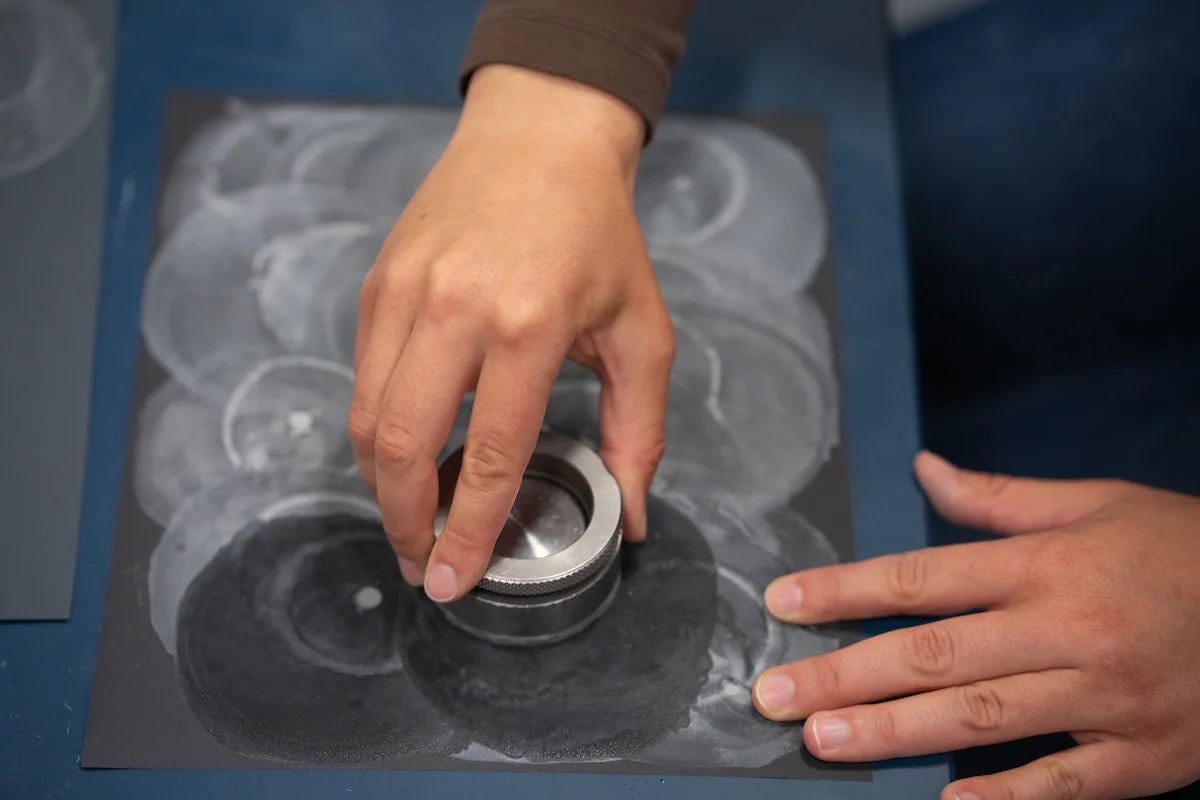 hands polishing an otolith