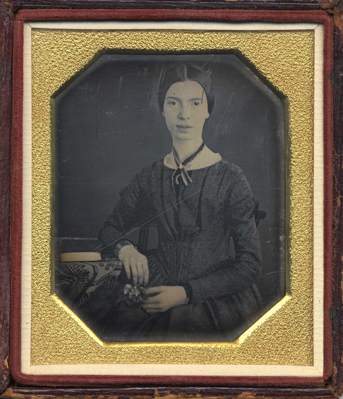 a vintage black and white portrait of Emily Dickinson in a wood and gold frame