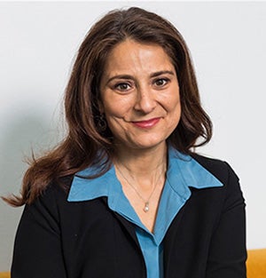 Professor Natalie Batalha smiles at the camera wearing a blazer and blue blouse