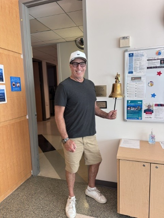 Tyler Callaway rings a bell in a hospital room, celebrating the completion of his cancer treatment.