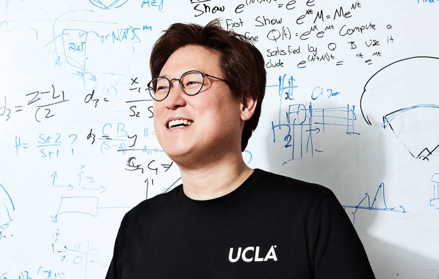Dennis Hong in front of a whiteboard