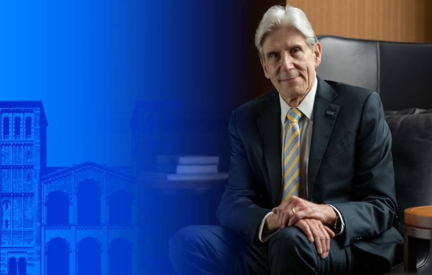 On the left side of the image, UCLA's Royce Hall with a blue layer over it; on the right, a man with a blue and gold tie, white hair, in a suit in a wood-paneled office (Dr. Frenk)
