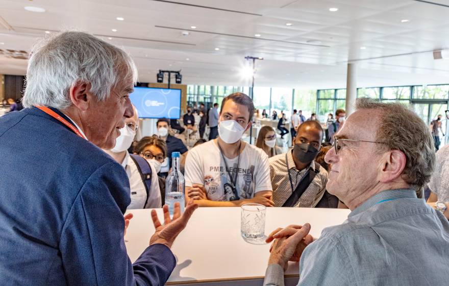Randy W. Schekman (on the right) and Martin Vetterli speak in front of masked students