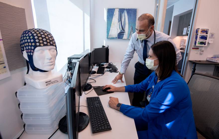 Two medical professionals looking at a computer together